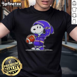 Premium Peanuts Snoopy in a hoodie smiling at fans, showcasing Baltimore Ravens spirit on a fun t-shirt design.