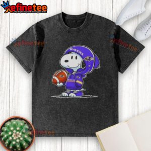 Premium Peanuts Snoopy wearing a Baltimore Ravens hoodie, smiling at fans on a washed t-shirt design.