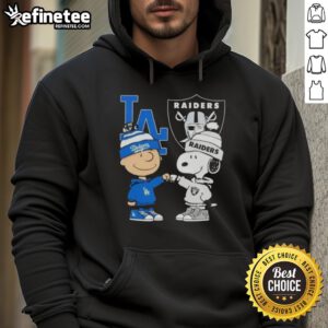 Alt Text: Awesome Charlie Brown fist bump with Snoopy in Los Angeles Dodgers and Raiders hoodie, showcasing city sports spirit.
