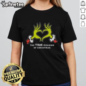 Grinch hands forming a heart on a Christmas ladies tee, showcasing the true meaning of Christmas with festive spirit.