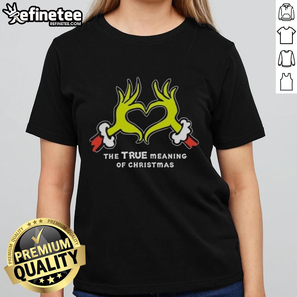 Grinch hands forming a heart on a Christmas ladies tee, showcasing the true meaning of Christmas with festive spirit.