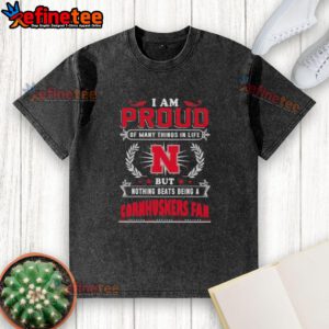 Washed t-shirt featuring 'Proud to be a Nebraska Cornhuskers fan' design, perfect for loyal sports enthusiasts.