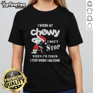 Alt Text: Snoopy graphic on a Christmas ladies tee with 'I work at Chewy, I don't stop when I'm tired' slogan.