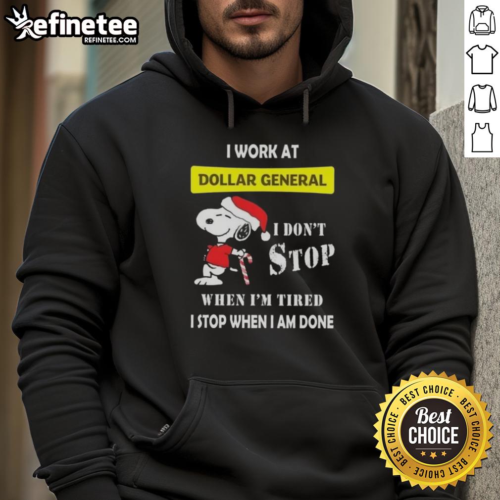 Alt Text: Christmas hoodie featuring Snoopy and the phrase 'I work at Dollar General, I don't stop when I'm tired, I stop when I'm done.'