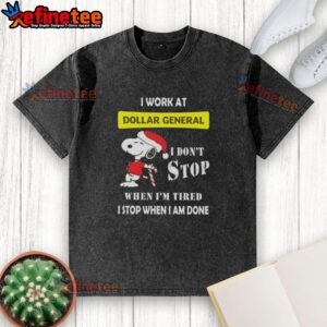 Alt Text: Snoopy graphic on a Christmas t-shirt reading 'I work at Dollar General, I don't stop when I'm tired, I stop when I'm done.'