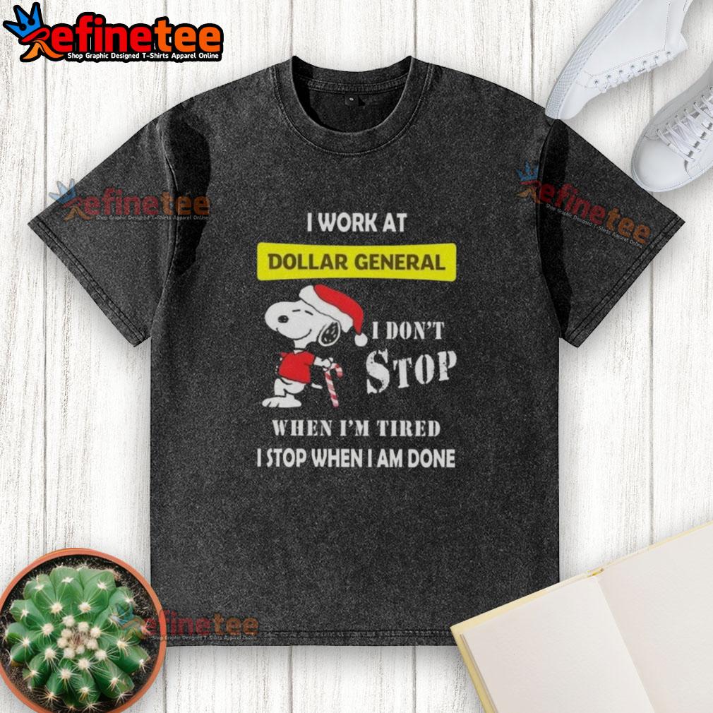 Alt Text: Snoopy graphic on a Christmas t-shirt reading 'I work at Dollar General, I don't stop when I'm tired, I stop when I'm done.'