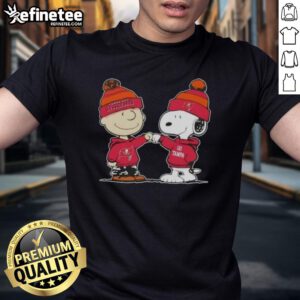 Official Peanuts Charlie Brown fist bump with Snoopy on Tampa Bay Buccaneers football T-shirt design.