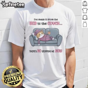Top tired cat wearing 'I've made it from the bed to the couch, there's no stopping me now' T-shirt, lounging comfortably.