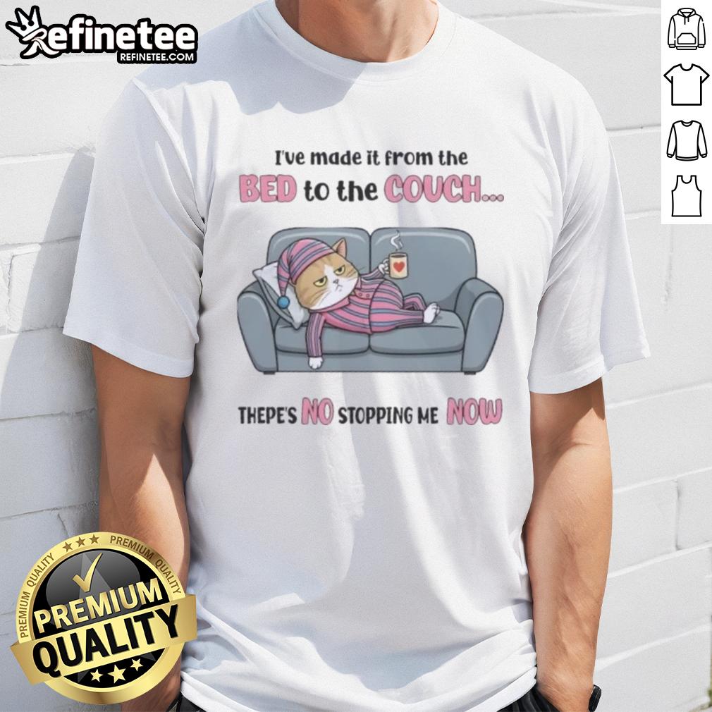 Top tired cat wearing 'I've made it from the bed to the couch, there's no stopping me now' T-shirt, lounging comfortably.