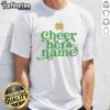 Top University of Notre Dame Cheer Her Name logo T-shirt featuring vibrant design and school spirit colors.