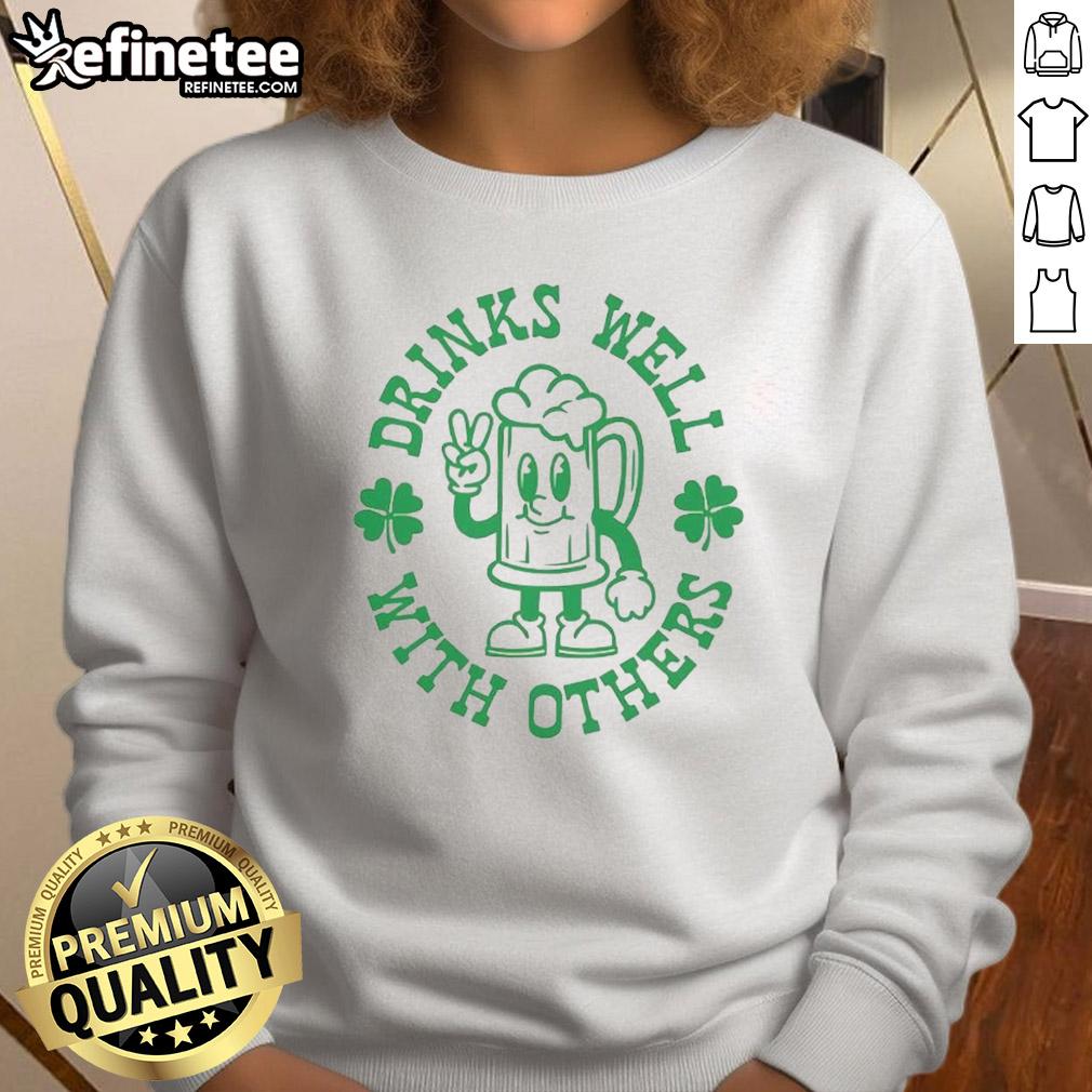 Green St. Patrick's Day sweatshirt featuring 'Official Drinks Well With Others' design, perfect for festive celebrations.