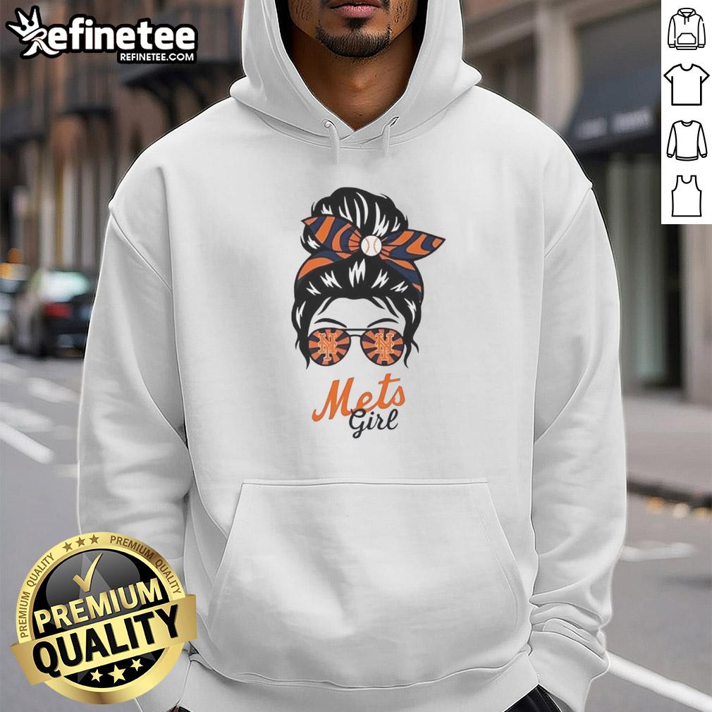 Official New York Mets girl in a messy bun wearing glasses and a hoodie, showcasing team spirit and style.