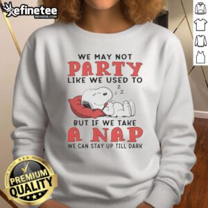 Cozy sweatshirt featuring Snoopy with 'We may not party like we used to' quote, perfect for casual wear and napping.