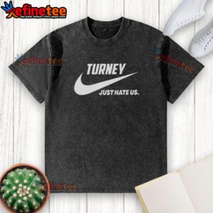 Official Turney Just Hate Us parody logo on a washed t-shirt, featuring a playful design for casual wear.