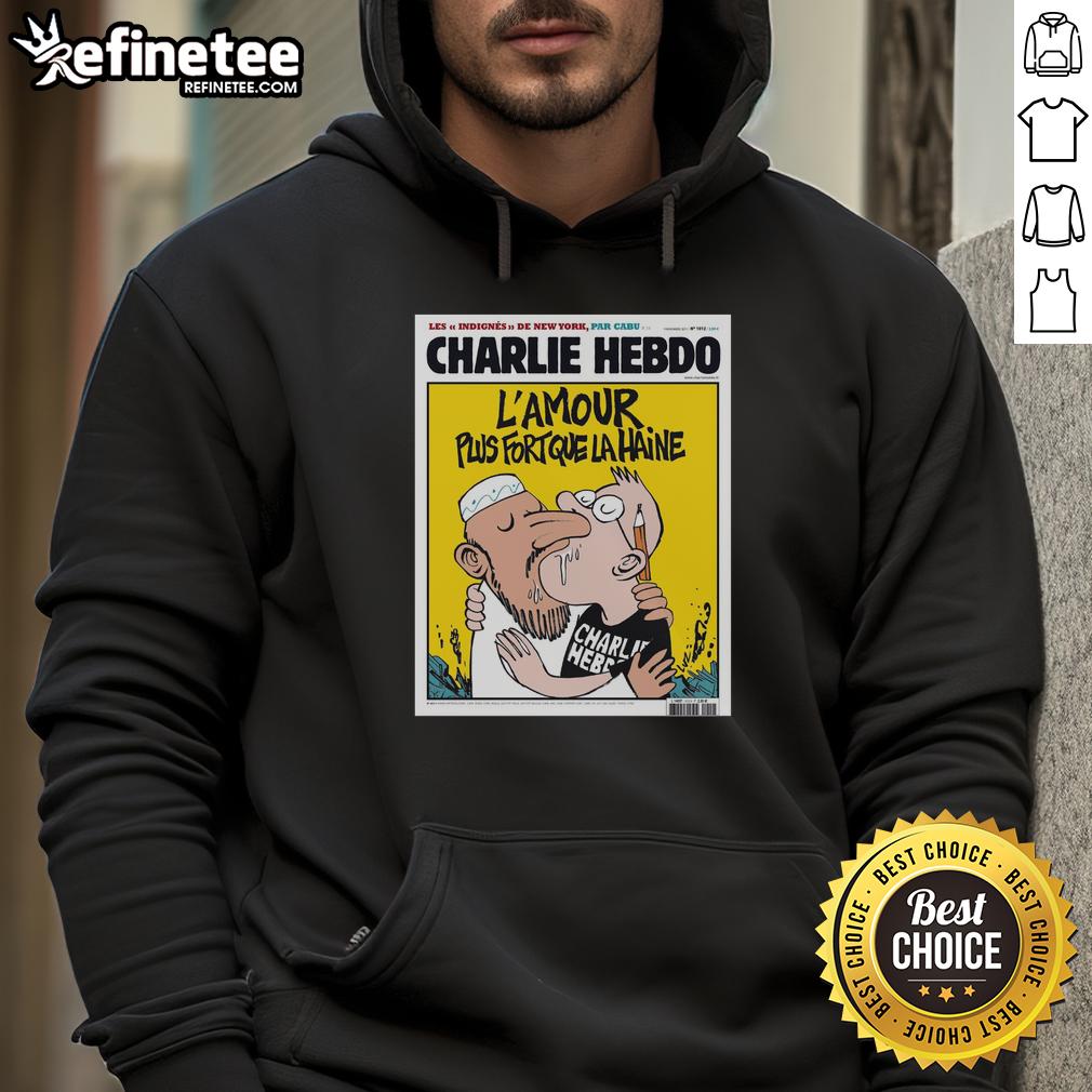 Two men kissing while wearing the 'Charlie Hebdo L'Amour Plus Fort Que La Haine' hoodie, symbolizing love and unity.