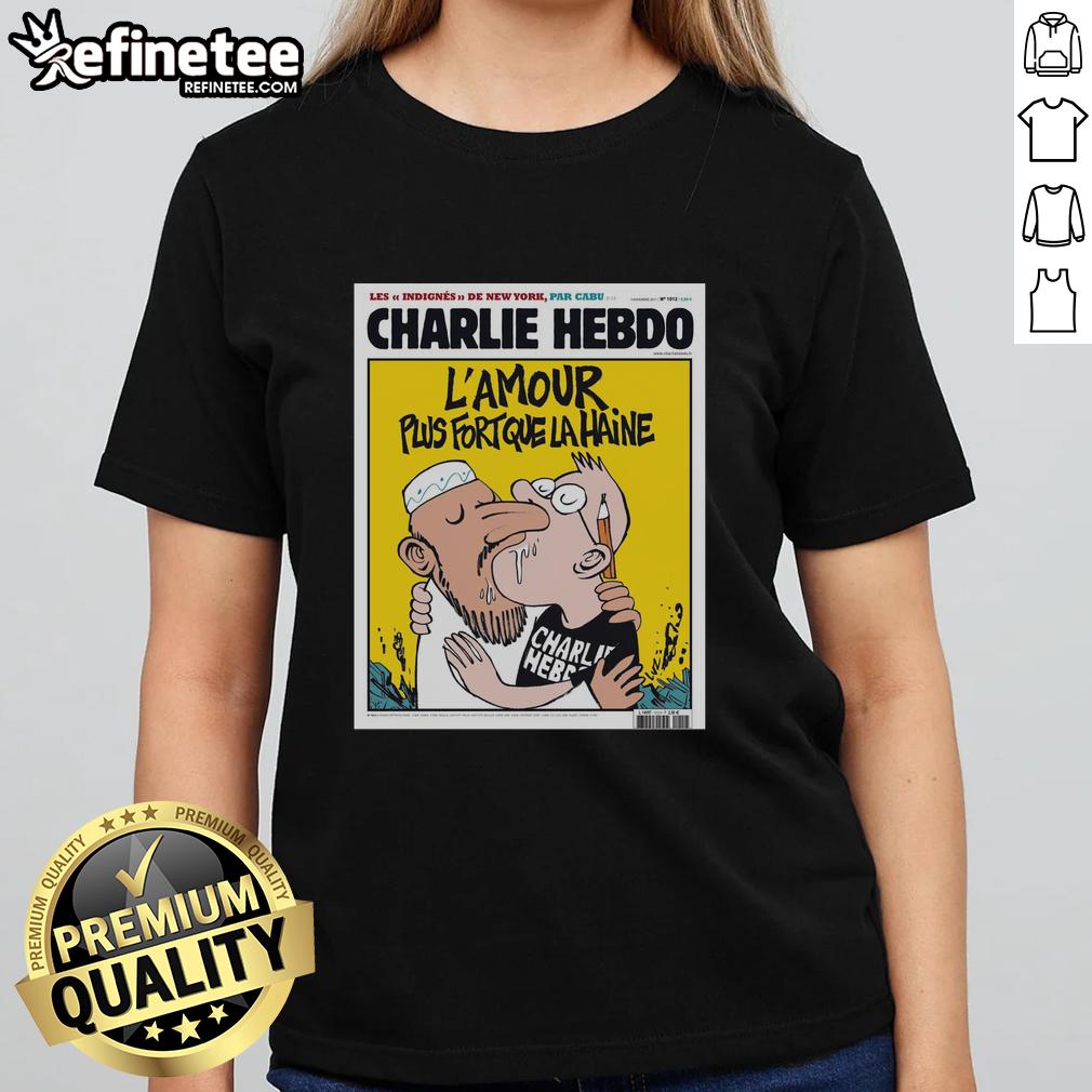 Alt Text: Official Charlie Hebdo tee featuring two men kissing, symbolizing 'L'Amour Plus Fort Que La Haine' message of love.