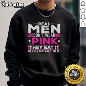 Alt Text: Original Real Men Don't Wear Pink They Eat It Sweatshirt featuring bold text and vibrant colors for men's fashion.