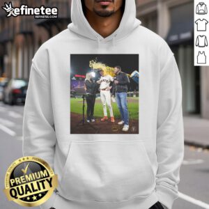 Daniel Susac in a San Francisco Giants hoodie, as water is playfully thrown on him during a fun team celebration.