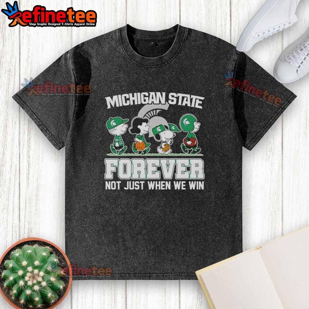 Alt Text: Cartoon characters on a washed t-shirt featuring Top Peanuts X Michigan State Spartans Forever Fan slogan.