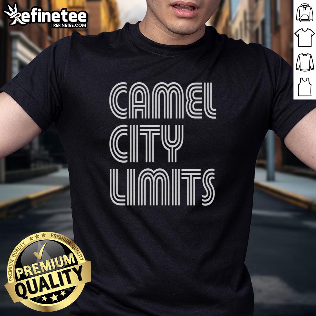 Good Tressie McMillan Cottom Camel City Limits T-Shirt displayed on a wooden background, showcasing its vibrant design.