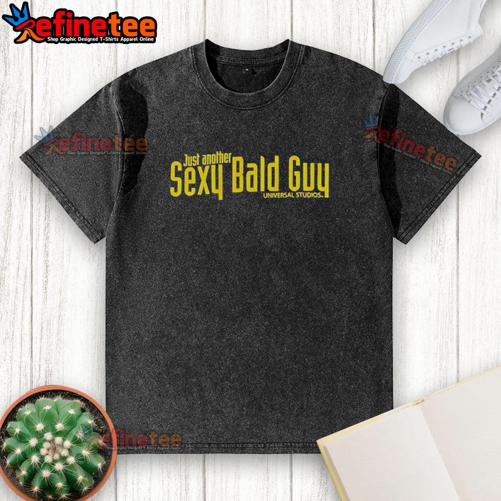 Hot bald guy wearing a washed Universal Studios t-shirt, showcasing a stylish and relaxed look.
