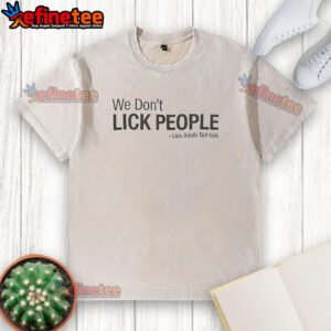 Premium We Don't Lick People Lies Adults Tell Kids washed t-shirt displayed on a wooden background, perfect for humorous gifts.