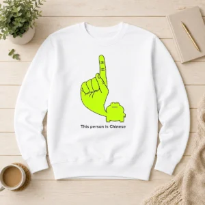 Top This Person Is Chinese Green Frog Pointing Finger Meme sweater in green with printed frog graphic and text
